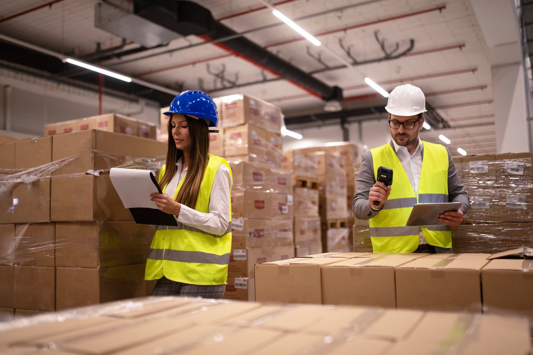 warehouse-workers-using-bar-code-scanner-tablet-checking-goods-inventory (1)